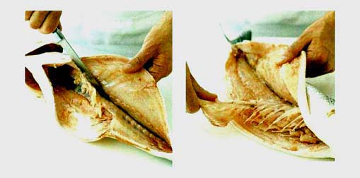 Разделка рыбы овальной формы на филе фотография